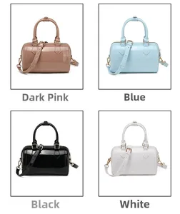 Detail view of mini Boston jelly bags in four glossy candy colors with gold hardware