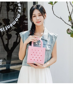 Close-up of pink EVA tote bag with hole design carried by model in a bright setting