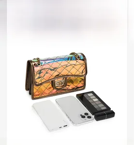Capacity detail of iridescent PVC crossbody bag with chain strap and quilted pattern