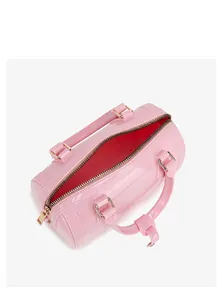 Spacious interior of a pink PVC jelly bag showing storage capacity and golden hardware