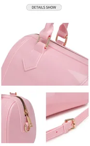 Close-up of pink PVC jelly bag showing glossy material and polished gold-tone hardware