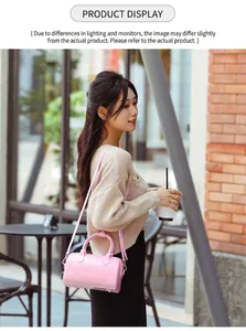 Detailed view of pink PVC jelly Boston bag with glossy finish and top handles