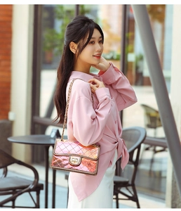 Detail shot of the metallic pink quilted crossbody bag with a classic gold turn-lock closure