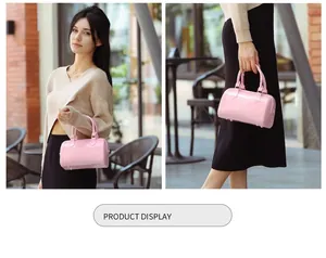 Detailed macro view of pink jelly PVC Boston bag showing glossy texture and D-ring