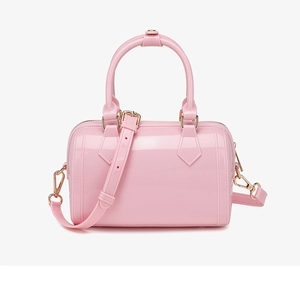Detailed close-up of glossy pink PVC jelly bag with shiny light gold hardware accents