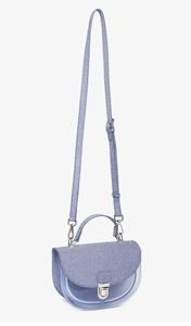Détail du rabat en tissu rayé bleu et du corps en PVC transparent du sac de selle