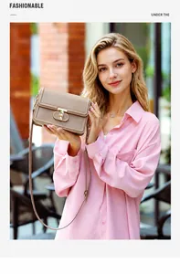 Detail of elegant beige PU leather mini bag with golden D-shape metal buckle lock and strap