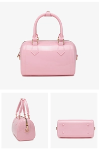 Detail view of pink PVC jelly handbag showing bottom metal rivets and glossy finish