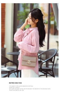 Detail view of khaki PU leather crossbody bag featuring a golden metal lock on a model