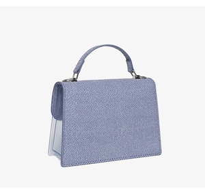 Detail view of light blue jelly bag featuring blue striped fabric and transparent PVC panels