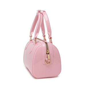 Pink PVC jelly Boston handbag with macaron tones and golden hardware on white background