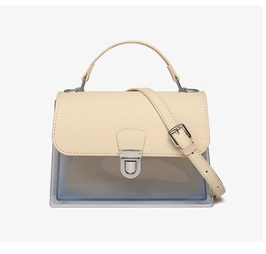 Front view of cream canvas and transparent PVC crossbody bag with golden metal twist lock
