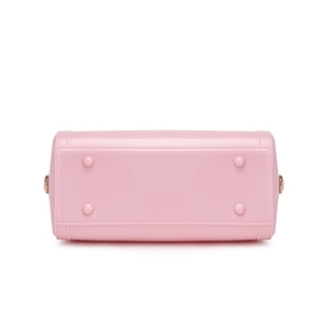 Pink PVC jelly handbag showing the bottom base with anti-wear studs and neat stitching