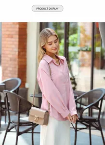 Fashionable khaki mini crossbody bag with metal buckle worn with casual pink shirt