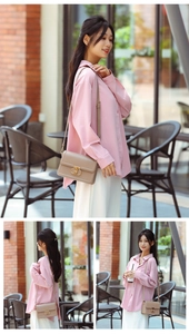 Detail of light khaki mini crossbody bag with gold buckle on a stylish outdoor model