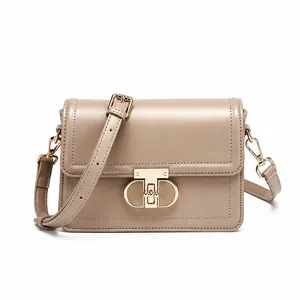 Detailed macro view of the smooth PU leather surface and gold D-ring buckle on a mini bag