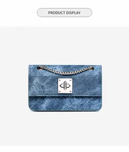 Detailed close-up of blue denim texture and silver metal twist lock on a chain bag