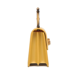 Bolso de mano amarillo mostaza en cuero PU con asa de bambú y diseño de acordeón