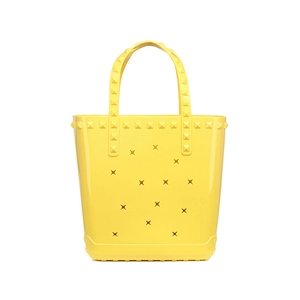 Bright yellow EVA beach tote bag with pyramid studs and X-shaped hollow out design
