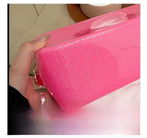 Detailed close-up showing precision stitching on a pink glitter transparent PVC bag
