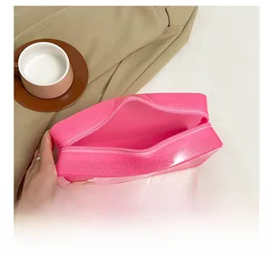 Close-up of pink translucent glitter makeup bag with zipper opening and spacious interior