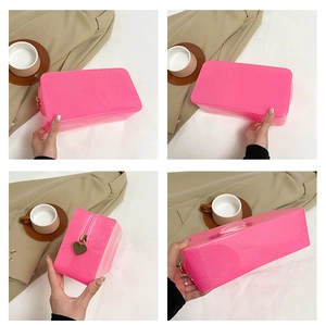 Detailed views of a pink glitter makeup bag with a heart-shaped metal zipper pull