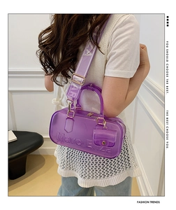 Detail of purple transparent PVC jelly bag with wide logo strap and mini coin pouch accessory
