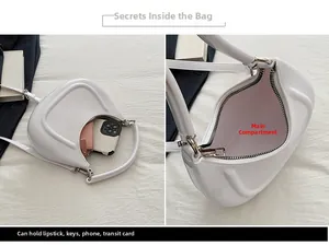 Detail view of the white crescent bag interior showing storage for phone and cards