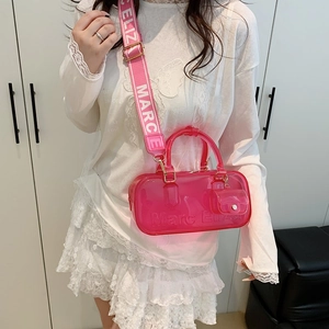 Hot pink translucent PVC Boston bag with wide woven strap and mini coin purse charm
