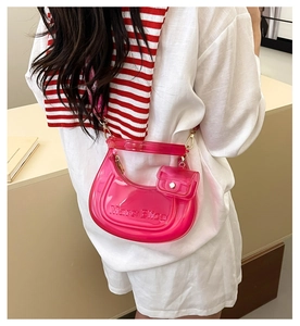 Detail of translucent jelly bag in neon pink with Marc Eliza logo and small pouch