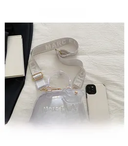 Detail view of transparent PVC jelly bag with Marc Eliza logo strap and gold hardware
