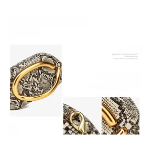 Detailed close-up of snake print bucket bag showing gold metal handles and texture