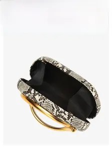 Detail view of snakeskin bucket bag with matte gold circular metal handle and black lining