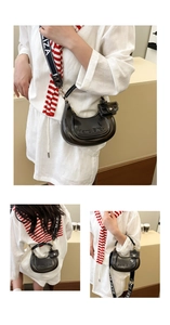 Detail of black translucent jelly bag with branded logo and lettered wide strap