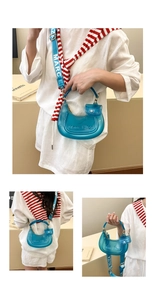 Detail of bright blue jelly crescent bag with wide logo strap and detachable mini pouch