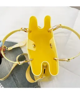 Detail view of the yellow tote bag showing the magnetic closure and wide logo strap