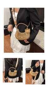 Detailed view of a brown transparent crescent bag with a mini pouch and jacquard strap