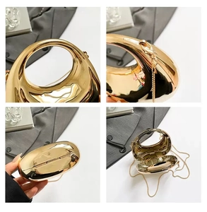 Detail view of gold metal evening bag featuring hollow handle and detachable chain strap