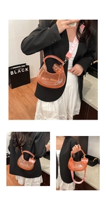Macro detail of orange translucent PVC jelly bag with wide woven strap and brand text