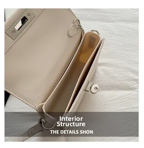 Macro shot of cream-colored cross-grain leather bag with metallic twist lock and interior