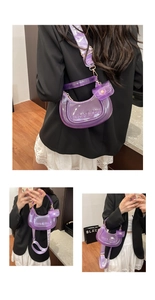 Detail view of purple transparent PVC crescent bag with mini purse and jacquard strap