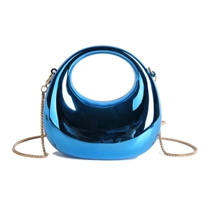 Close-up of electric blue metallic mini bag featuring mirror finish and gold snake chain