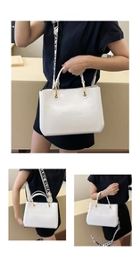 Detailed view of white patent leather bag with gold hardware and MARC ELIZA woven strap