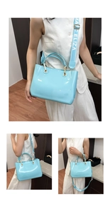 Detail view of sky blue jelly tote bag with woven logo strap and gold hardware