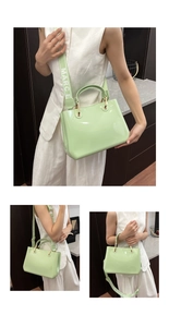 Three-way view of mint green patent leather tote bag with a wide branded shoulder strap