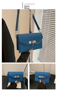 Detailed macro view of deep blue cross-grain leather texture and metal lock on kelly bag