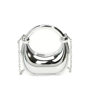 Detail view of the metallic silver half-moon bag featuring a sleek ring handle and chain