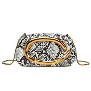 Chic black and white snakeskin bucket bag with gold hardware and snake chain strap