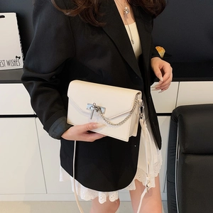 Elegant cream white Kelly crossbody bag with textured leather and metal chain lock