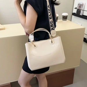 Chic cream white patent leather tote bag with branded wide strap and glossy finish